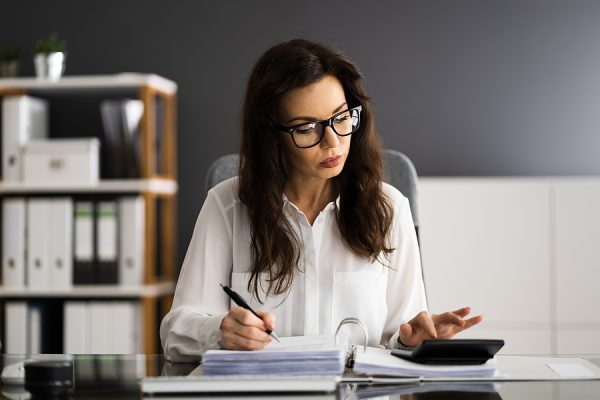 Woman reading about energy saving ideas to save money on energy costs