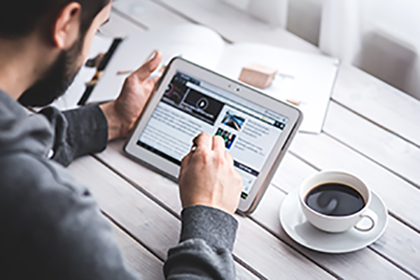 Man using tablet to complete budget planner to save money